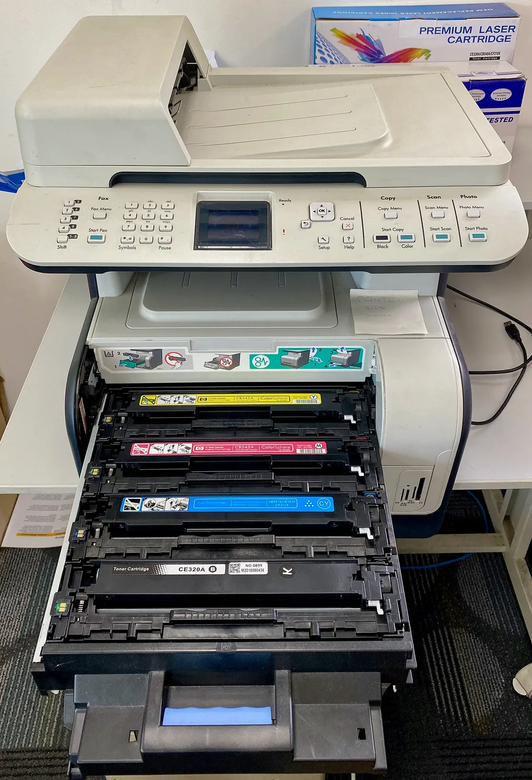 HP LaserJet printer showing paper tray and toner compartment