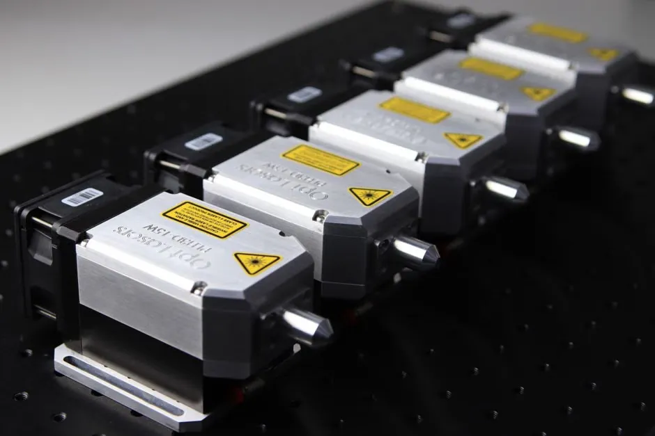 Close-up of genuine laser printer toner cartridges from HP, Brother, OKI and Epson on an office desk
